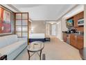 Relaxing bedroom featuring a cozy seating area, bed, and convenient kitchenette at 125 E Harmon Ave # 511, Las Vegas, NV 89109
