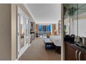 Main bedroom featuring sitting area, desk, city views, and a bar area at 125 E Harmon Ave # 511, Las Vegas, NV 89109