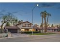 Charming two-story home featuring desert landscaping and a red tile roof at 1251 Los Meadows Dr, Las Vegas, NV 89110