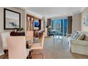 Spacious living room featuring comfortable seating, a dining area and a large window offering city views at 135 E Harmon Ave # 1621, Las Vegas, NV 89109