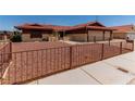 Charming home featuring a red tile roof, low maintenance landscaping, and an attached two-car garage at 1513 Brocado Ln, Las Vegas, NV 89117