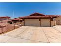 This charming home has a red tile roof, low maintenance front yard, and an attached two-car garage at 1513 Brocado Ln, Las Vegas, NV 89117
