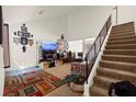 Bright living room featuring high ceilings, staircase and carpeted floors, ideal for comfortable living at 165 Spinnaker Dr, Henderson, NV 89015