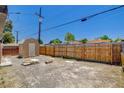 Spacious backyard featuring a wood fence, utility shed, and ample room for recreation at 1708 Cedar Ave, Las Vegas, NV 89101