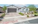 Charming single-story home featuring a well-kept front yard with block wall and lush green shrubs at 172 Lunga Ave, Henderson, NV 89011