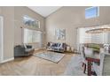 Bright living room featuring wood-look tile flooring, high ceilings, and large windows for ample natural light at 1780 Crystal Stream Ave, Henderson, NV 89012