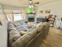 Cozy living room with a fireplace, ceiling fan, and comfortable sectional sofa at 2016 Mesquite Ln # 302, Laughlin, NV 89029