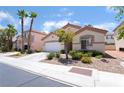 Well-maintained single-story home with desert landscaping, a two-car garage, and a red tile roof at 203 Sea Rim Ave, Las Vegas, NV 89148