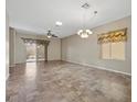 Spacious living room with tile floors, ceiling fan, and natural light at 2117 Bay Thrush Way, North Las Vegas, NV 89084