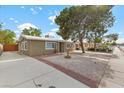 View of front exterior features desert landscaping, and a paved driveway at 2408 Berkley Ave, Las Vegas, NV 89101