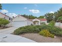 Charming single-story home with a well-manicured lawn and a two-car garage at 3201 Beacon Shores Cir, Las Vegas, NV 89117