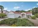 Charming single-story home with a well-manicured lawn and a two-car garage at 3201 Beacon Shores Cir, Las Vegas, NV 89117