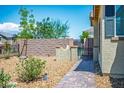 Landscaped side yard with brick paver walkway and privacy wall at 3484 Bradano Ln, Henderson, NV 89044