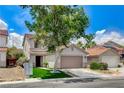 Two-story home showcasing a two-car garage, manicured lawn, and drought resistant landscaping at 3717 Shanagolden St, Las Vegas, NV 89129