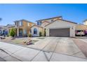 Two-story home with attached two-car garage, xeriscaped front yard and paved driveway at 4429 E Azure Ave, Las Vegas, NV 89115