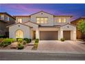 Charming two-story home with a well-manicured front yard and a three-car garage at 454 Rosina Vista St, Las Vegas, NV 89138