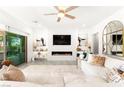 Bright living room featuring a modern fireplace, plush seating, and access to the backyard at 454 Rosina Vista St, Las Vegas, NV 89138