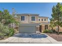 Two-story home featuring a 2-car garage, stone accents and neutral colored stucco with professionally landscaped yard at 4744 Deer Forest Ave, Las Vegas, NV 89139