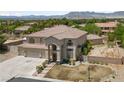 Expansive property showcasing a tile-roofed home with a large driveway and mountain views at 4883 Grey Mesa St, Las Vegas, NV 89149