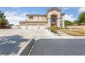 Elegant two-story home with a three-car garage, complemented by a well-maintained front yard at 4883 Grey Mesa St, Las Vegas, NV 89149