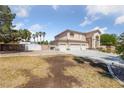 Spacious home featuring a three-car garage and ample yard space, perfect for outdoor activities at 4883 Grey Mesa St, Las Vegas, NV 89149
