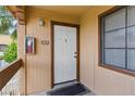 Inviting condo entrance showcasing a white front door, brown trim, and well-lit exterior with unit number 205 at 5166 S Jones Blvd # 205, Las Vegas, NV 89118