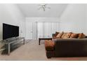 Inviting living room with neutral walls and carpet, ample lighting, and a large sofa at 5166 S Jones Blvd # 205, Las Vegas, NV 89118