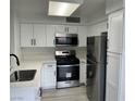 Well-equipped kitchen with stainless steel appliances, white cabinets, and a functional layout at 5222 Mandalay Springs Dr # 202, Las Vegas, NV 89120