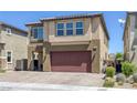 This lovely two-story home features a two-car garage, neutral stucco exterior, and manicured landscaping at 5966 Icicle Falls Ave, Las Vegas, NV 89130