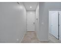 Well-lit entryway with a white front door, neutral walls, and light tile flooring at 5966 Icicle Falls Ave, Las Vegas, NV 89130