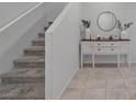 Foyer with neutral colors, tile flooring, staircase, and decorative sideboard at 5966 Icicle Falls Ave, Las Vegas, NV 89130