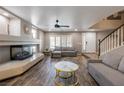 Bright living room with a cozy fireplace, wood flooring, and neutral decor, creating a comfortable atmosphere at 6251 Tuckaway Cove Ave, Las Vegas, NV 89139