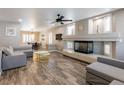 Open-concept living room featuring a modern fireplace, stylish furnishings, and views into the dining area at 6251 Tuckaway Cove Ave, Las Vegas, NV 89139
