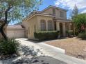 Charming two-story home with a two-car garage, desert landscaping, and a spacious driveway at 6797 Cardoness Ct, Las Vegas, NV 89139
