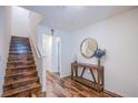 Inviting entryway with wood floors, a staircase, and stylish decor at 6819 Citron Mist Ct, North Las Vegas, NV 89086