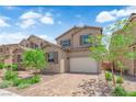Charming two-story home featuring a brick driveway, manicured lawn and neutral color palette at 69 Ella Ashman Ave, Henderson, NV 89011