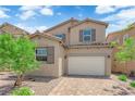 Charming two-story home featuring a brick driveway and neutral color palette at 69 Ella Ashman Ave, Henderson, NV 89011