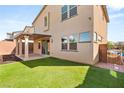This backyard features a covered patio, artificial grass and low-maintenance landscaping at 6901 Whisper Canyon Pl, North Las Vegas, NV 89084
