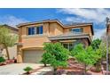 View of the two-story home's exterior, showcasing a two-car garage, well-maintained lawn and stone accents at 7372 S Palo Real Ct, Las Vegas, NV 89179