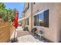 Charming outdoor patio with brick flooring, shaded seating, and string lights, perfect for relaxation and entertaining at 7928 Violet Dawn St, Las Vegas, NV 89149
