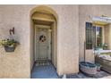 Inviting front entrance featuring a security door with patriotic wreath, stylish plants and modern outdoor accents at 7928 Violet Dawn St, Las Vegas, NV 89149