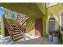 Exterior view of a condo entrance with a decorative door and stairs at 7950 W Flamingo Rd # 1003, Las Vegas, NV 89147