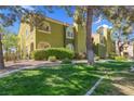 Exterior view of a well-maintained condo building with mature landscaping at 7950 W Flamingo Rd # 1003, Las Vegas, NV 89147