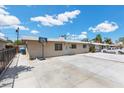 View of the side of the property featuring a driveway and access to the yard with adjacent neighboring property at 808 Reynolds Ave, North Las Vegas, NV 89030
