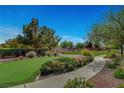 Well-maintained community green space with vibrant flowers and a putting green for residents to enjoy at 8564 Mayport Dr, Las Vegas, NV 89131