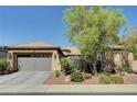 Charming single-story home with a two-car garage, lush landscaping, and stone accents on the exterior at 8564 Mayport Dr, Las Vegas, NV 89131