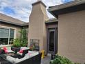 Enjoy outdoor relaxation in this cozy patio area with comfortable seating and a charming fireplace at 8564 Mayport Dr, Las Vegas, NV 89131