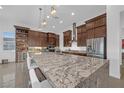Gourmet kitchen with a large island, stainless steel appliances, and custom cabinetry; perfect for entertaining at 9 Porto Malaga St, Henderson, NV 89011