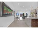 Open-concept living and dining area with modern finishes, a fireplace, and scenic backyard views at 9 Porto Malaga St, Henderson, NV 89011