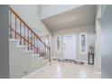 Inviting entryway with tile flooring, staircase, and neutral decor leading to the main living spaces at 9021 Feather River Ct, Las Vegas, NV 89117